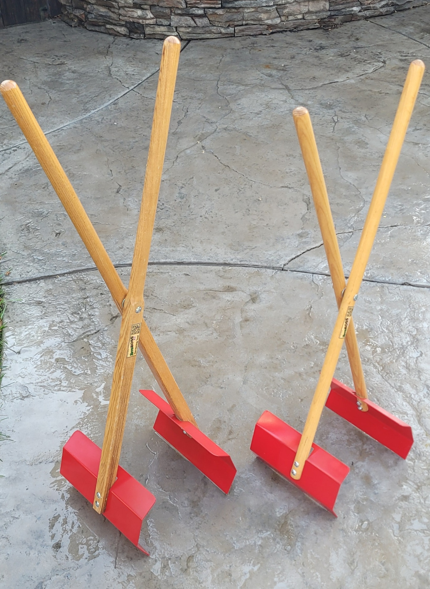 Two TerraBOSS tools standing side by side on a stone patio
