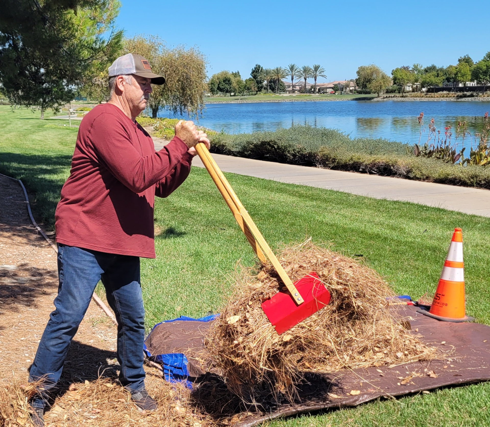 Lifting a large bundle of debris with the TerraBOSS near a lake